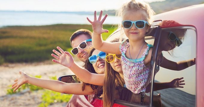 portraitofasmilingfamilywithtwochildrenatbeach-2